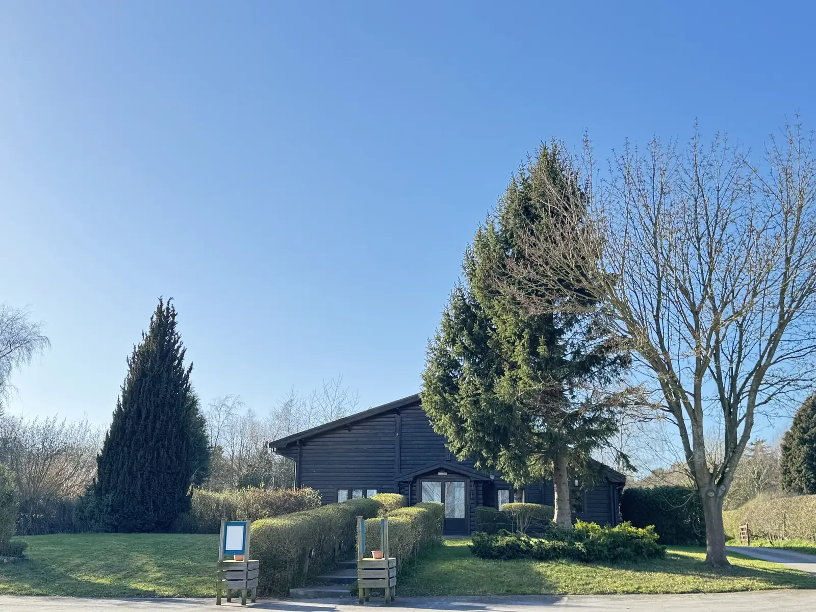 The Log Cabin at Vantom Villas set among trees and lawn
