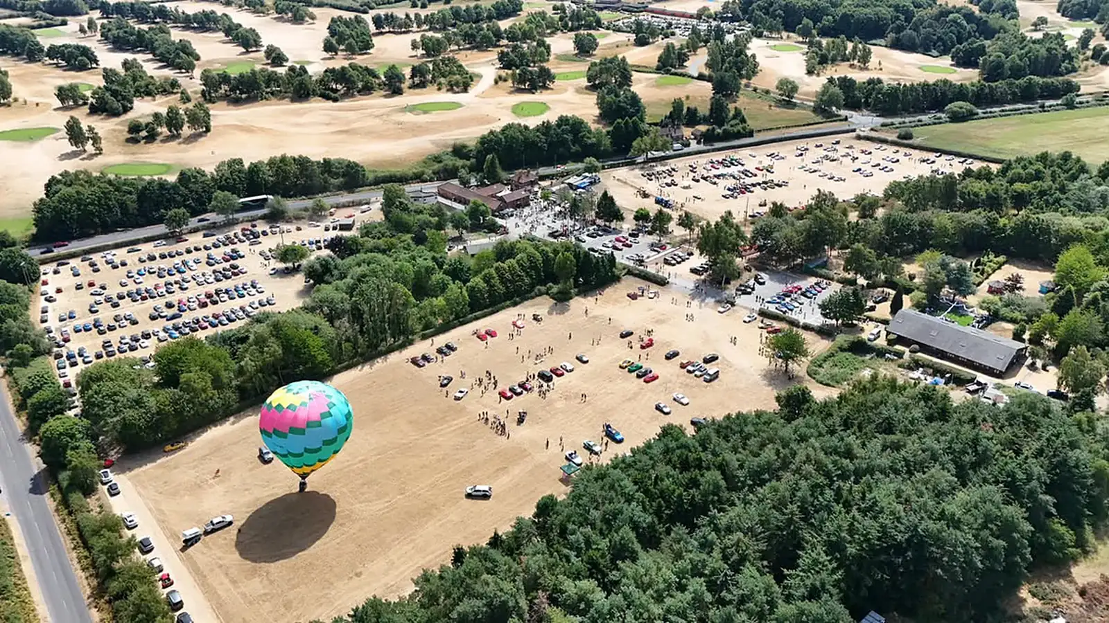 Hot-air balloon rising over the festival fields at Vantom Village