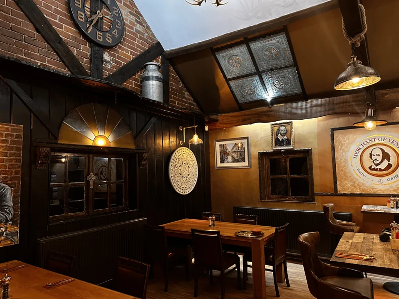 Merchant of Venice dining room with dark timber and warm lamps