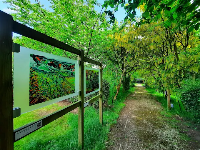 Garden path lined with trees and art panels