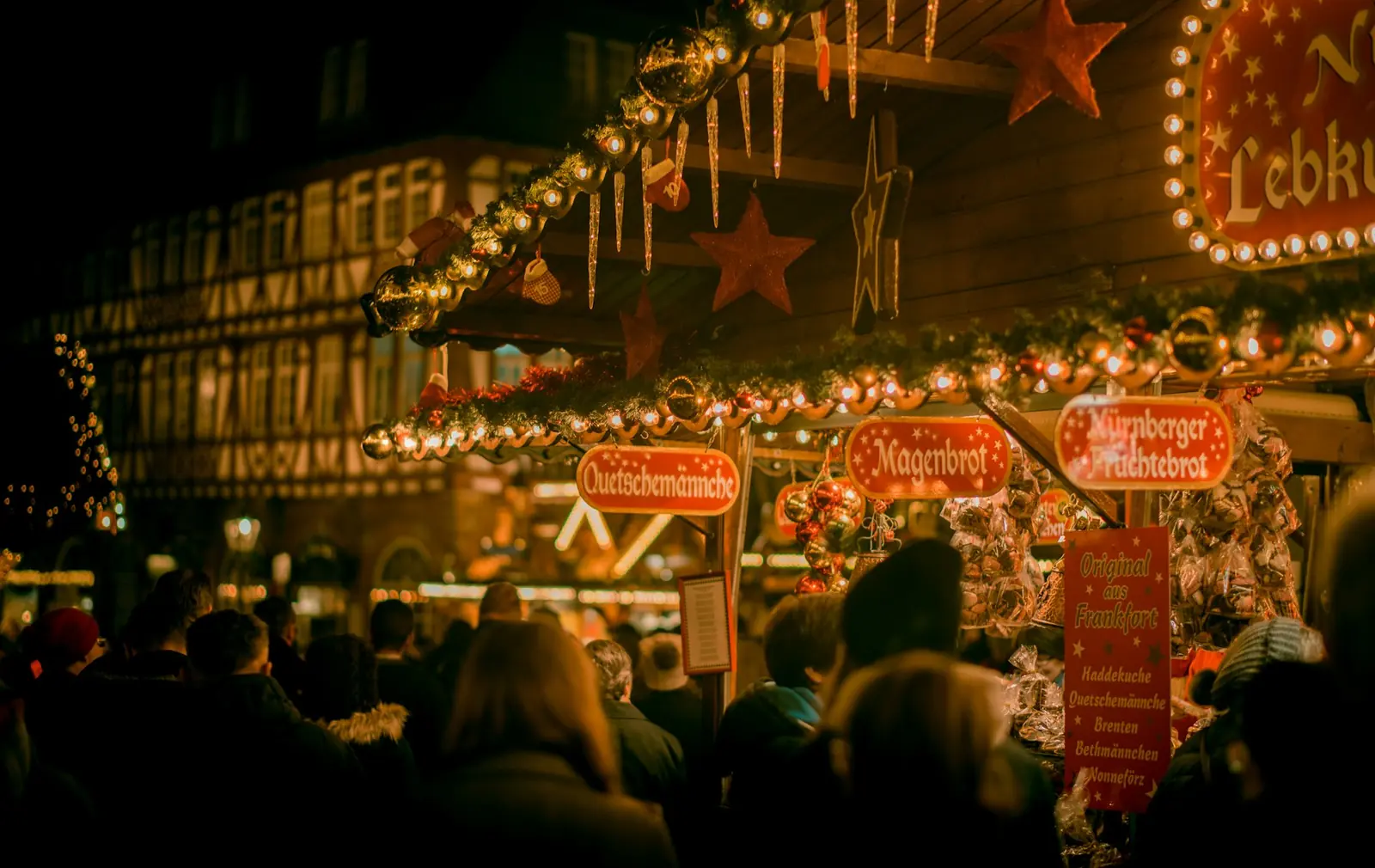 Crowd at a festive Christmas market at night